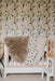 Sheepskin Nursing rugs in Toast, Spotted and Milk draped over a cot in a nursery