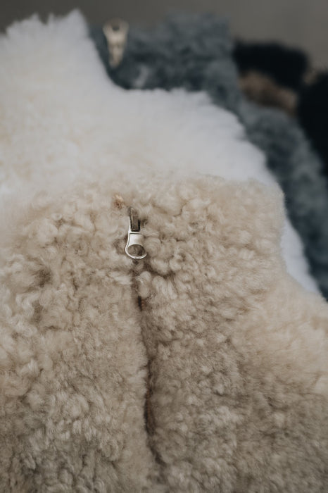 Close up image of mini sheepskin hot water bottle cover's zip