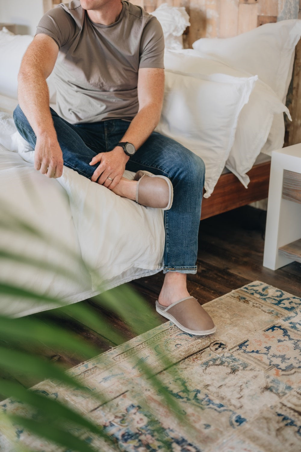 Wearing Sheepskin Slippers while Sat on bed. Mens Slip on Slippers prefect for putting on straight out of bed.