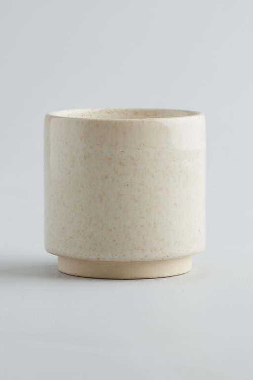 Bergamot & Nettle St. Eval fragranced candle in a sand coloured and inspired ceramic pot 