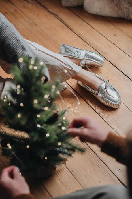 moccasin silver slipper under christmas tree