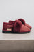 Durable women’s slippers with a natural shearling interior and red sheepskin upper.