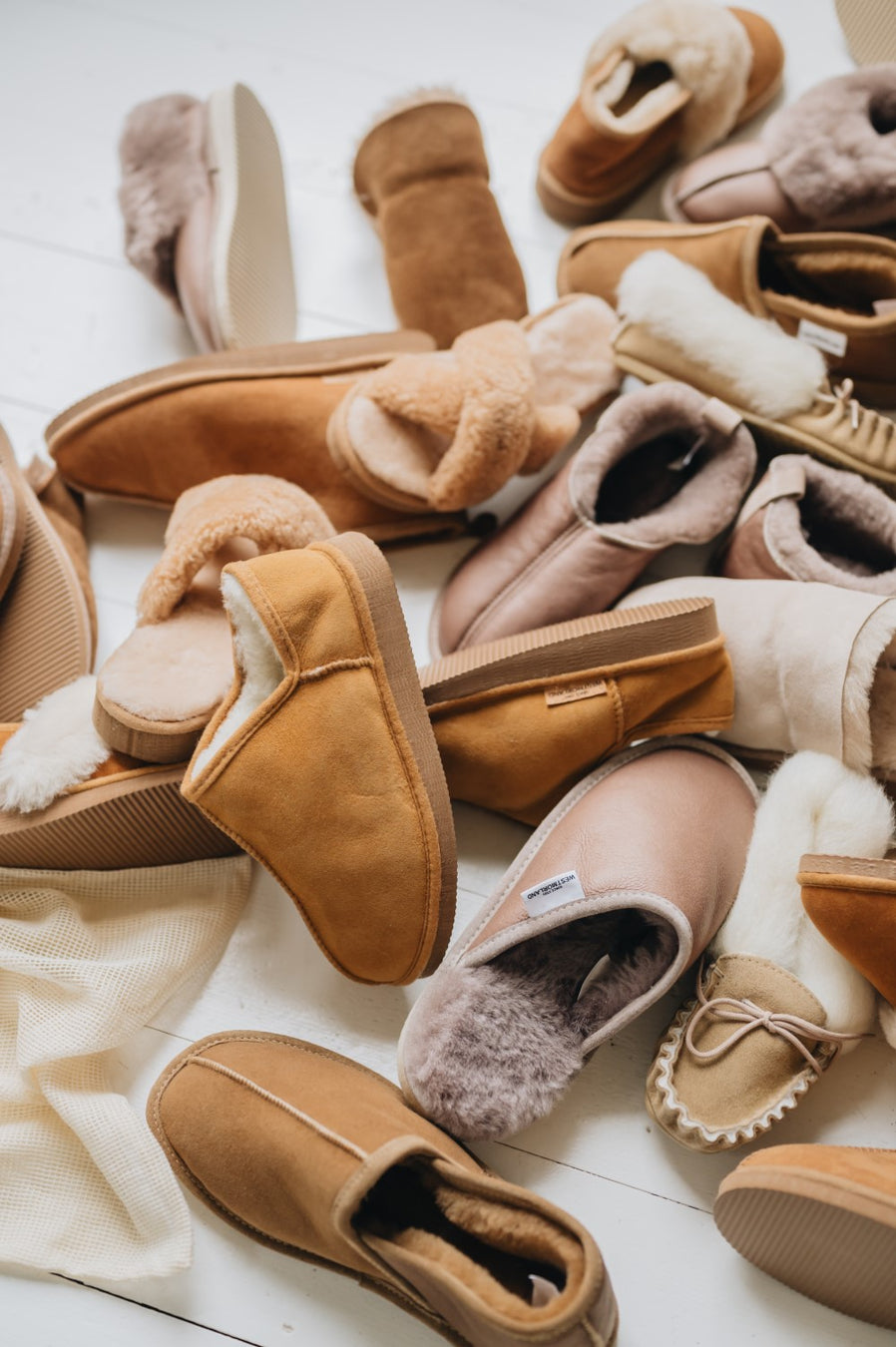 a mix of tan and brown sheepskin slippers