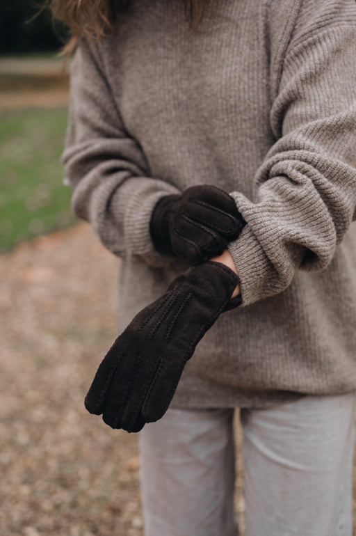 woman wearing sheepskin mittens brown