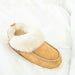 Womens Sheepskin Slipper by Shepherd of Sweden Colour Camel style on bed linen