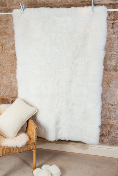 Icelandic Sheepskin Rug in White, draped over pole.